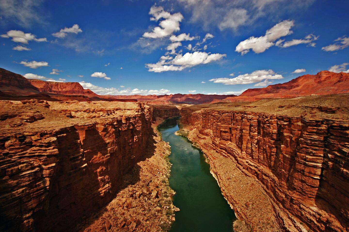 Visitors in 2011: 4,298,178 Established in 1919, the Grand Canyon is perhaps the most famous of America's national parks. It is an enormous stretch of canyon: 277 miles long (measured by the length of the river at its bottom), 6,000 vertical feet at its deepest and as much as 18 miles across in some places. It takes about two days to get to the bottom of the canyon and back on foot. And it receives close to 5 million visitors each year. More info: http://www.nps.gov/grca/index.htm