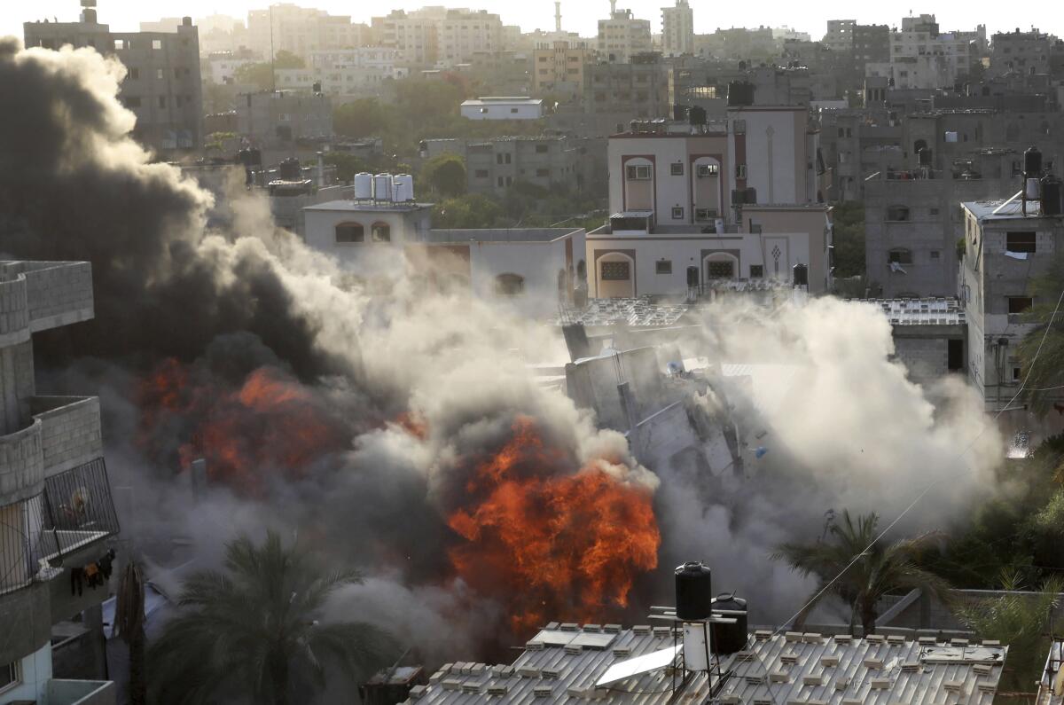 Smoke and fire rise from an explosion caused by an Israeli airstrike targeting a building.