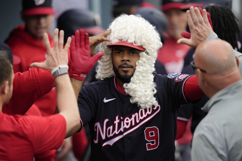 Washington Nationals third baseman Jeimer Candelario (9) celebrates in the dugout after hitting a home run during the fifth inning of a baseball game against the Los Angeles Dodgers in Los Angeles, Wednesday, May 31, 2023. Joey Meneses also scored. (AP Photo/Ashley Landis)