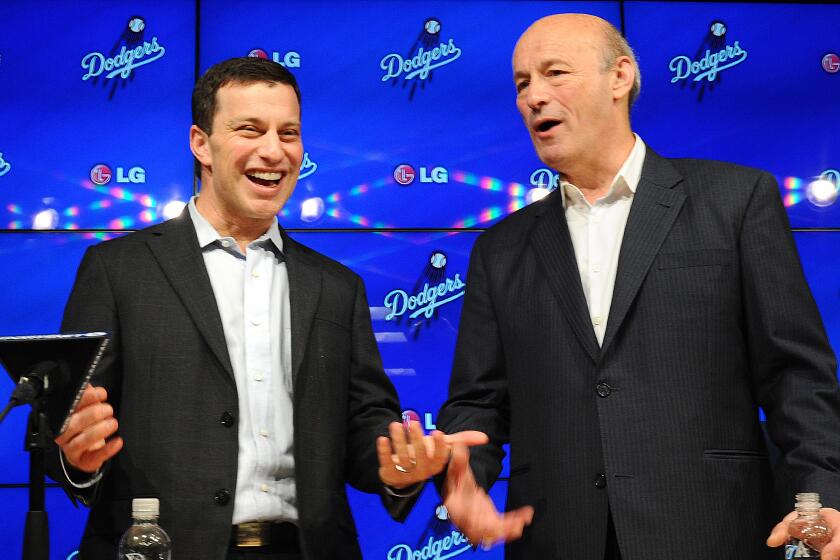 Andrew Friedman, the Dodgers' president of baseball operations, left, speaks with team President and CEO Stan Kasten during a news conference at Dodger Stadium on Oct. 17.