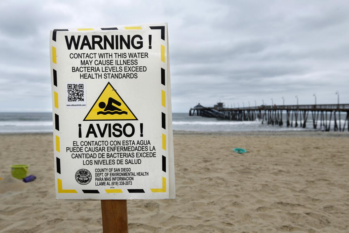 Signs warn beachgoers in Imperial Beach of high bacteria levels in the water.