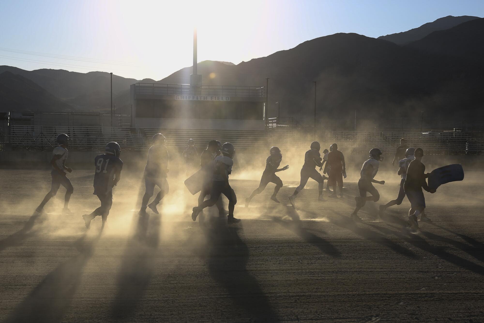 The Trona High football team practices in 108-degree weather on Aug. 14. The Sandmen have always played on a dirt-and-rock field.