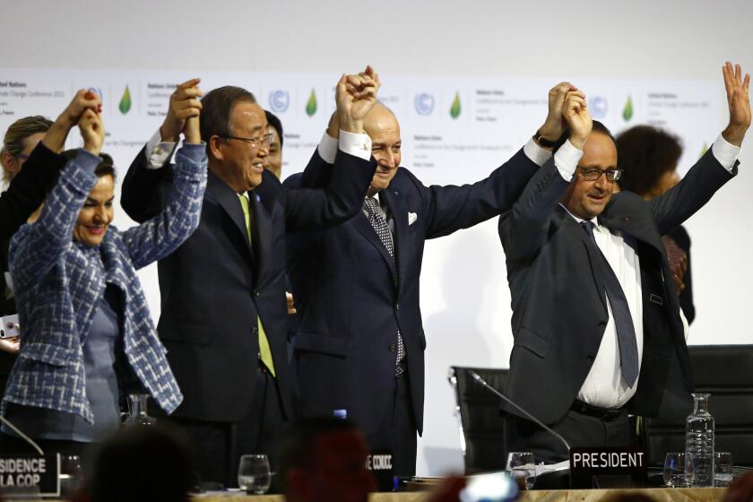 UN climate chief Christiana Figueres, UN Secretary General Ban Ki-moon, French Foreign Minister Laurent Fabius and French President Francois Hollande celebrate at the conclustion of the conference on climate change near Paris last December.