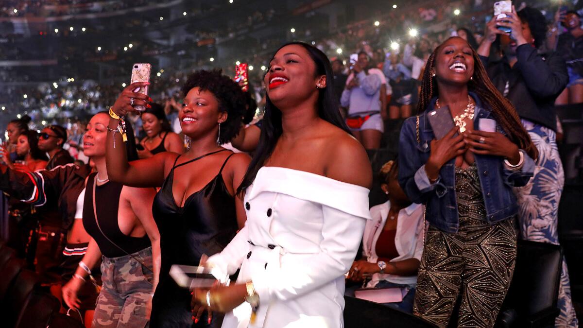 The audience reacts as Ella Mai performs.
