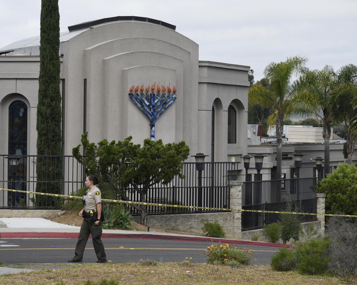 A San Diego County sheriff's deputy stands in front of the Chabad of Poway synagogue.