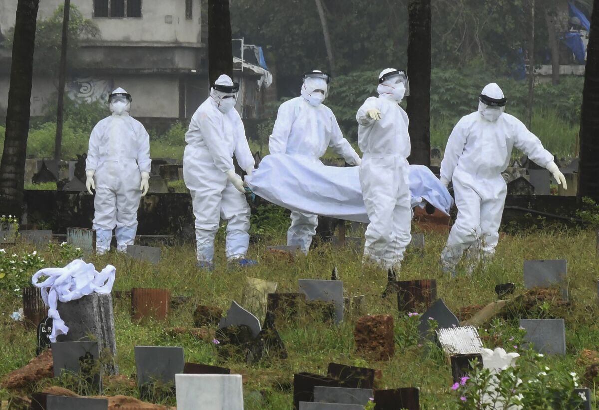 People in protective suits preparing to cremate body