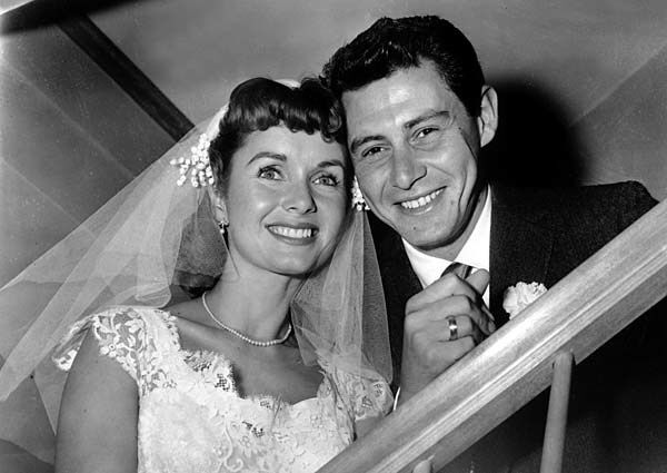 A Sept. 26, 1955, photograph shows actress Debbie Reynolds and singer Eddie Fisher after their marriage ceremony in Grossinger, N.Y. See full story