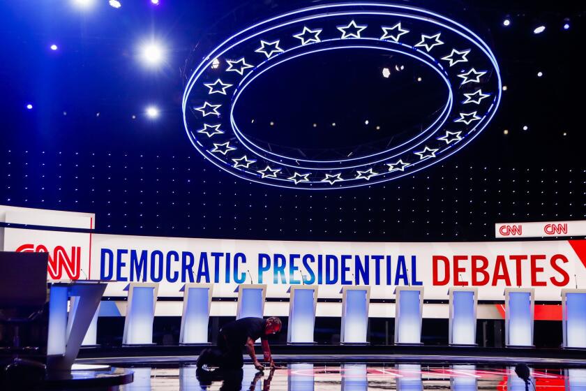 Workers get the stage ready for the Democratic primary debate hosted by CNN Tuesday, July 30, 2019, at the Fox Theatre in Detroit. (AP Photo/Carlos Osorio)