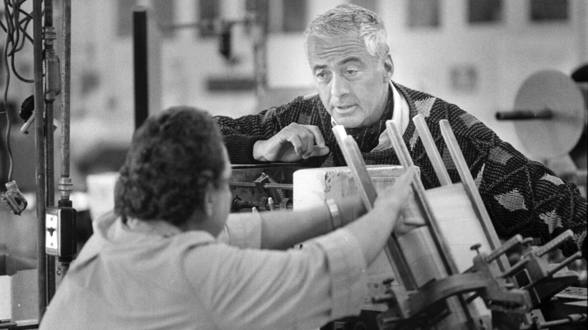 Lloyd Cotsen talks to a worker the Neutrogena factory in 1988.