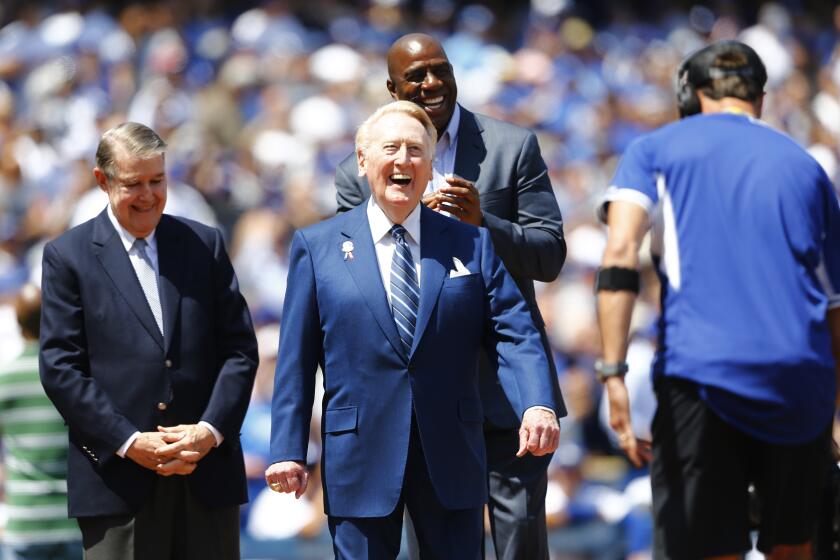 LOS ANGELES, CA - APRIL 12, 2016: Dodgers announcer Vin Scully is honored at home plate on his last Opening Day on April 12, 2016 at Dodger Stadium in Los Angeles, California. Former Dodgers owner Peter O'Malley is on the left and Magic Johnson is on the right.(Gina Ferazzi / Los Angeles Times)