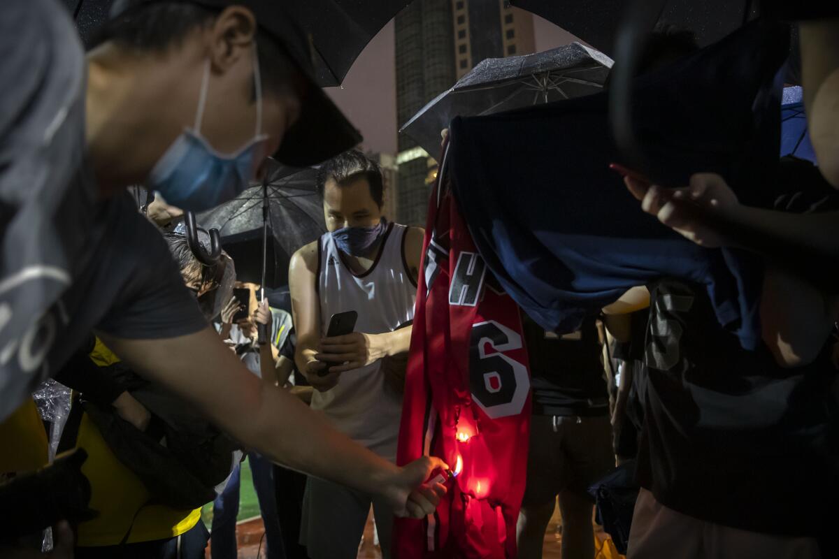 Demonstrators in Hong Kong set a LeBron James jersey on fire.