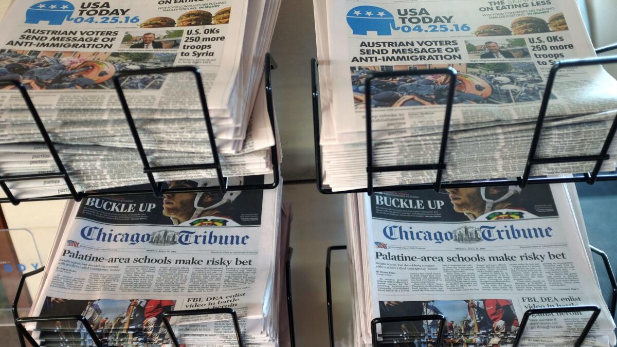 Copies of the Chicago Tribune and USA Today are displayed at Chicago's O'Hare International Airport.