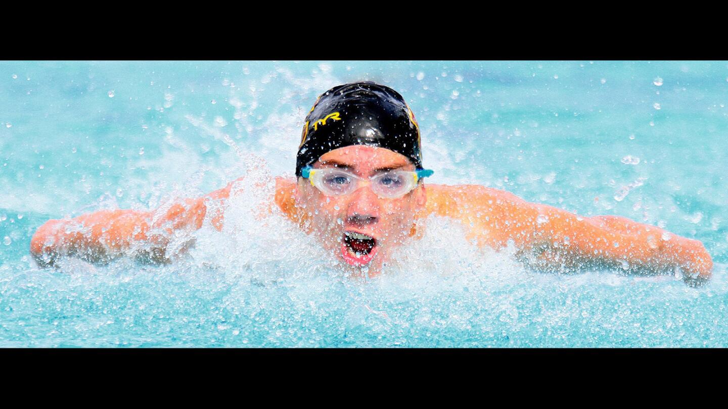 La Cañada's Eddie Cosic swims the butterfly leg of the 200 individual medley and wins in a swim meet at La Cañada High School on Tuesday, April 19, 2016. Flintridge Sacred Heart Academy and La Cañada girls teams competed, and St. Francis boys swam against La Cañada's boys.