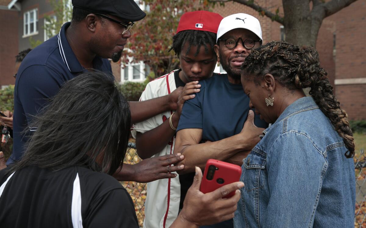 People pray after a school shooting.