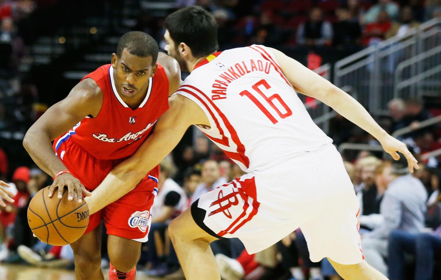 Clippers point guard Chris Paul drives past Rockets forward Kostas Papanikolaou in the second half.