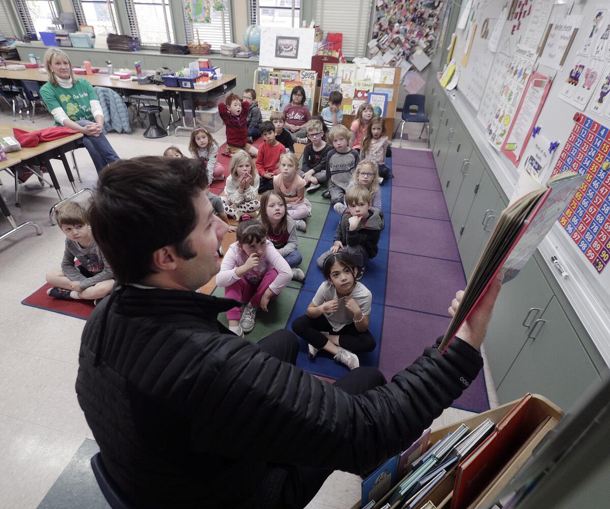 Kenny Schopp, Chick-fil-A franchise owner, reads the Dr. Seuss book "McElligot's Pool" to Kathy Wills-Sarna's kindergarten class at Roosevelt Elementary School on March 2.