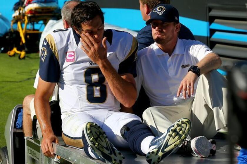 Rams quarterback Sam Bradford is carted off the field after sustaining an injury when he was knocked out of bounds by Mike Mitchell of the Panthers on Sunday afternoon in Charlotte, N.C.