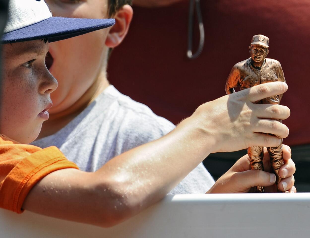Jameson Francis, 8, of Parkton, holds the fan giveaway, a miniature version of the Earl Weaver statue.