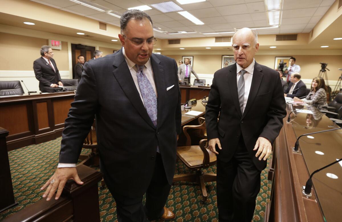 John Perez (D-Los Angeles), then the Assembly speaker, and Gov. Jerry Brown leave a legislative hearing in April where they discussed a proposed rainy day fund ballot measure.