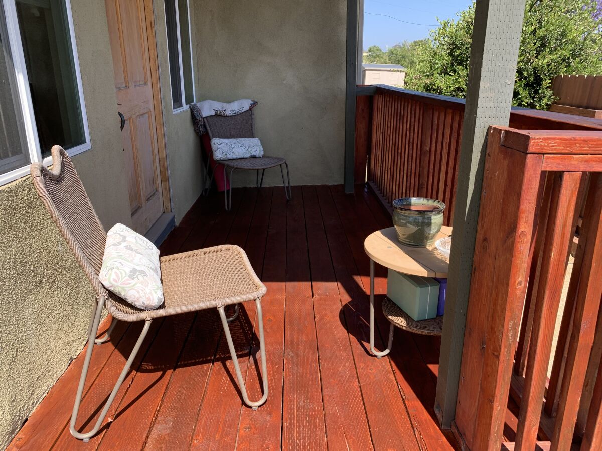 A deck that's been sanded and painted red.