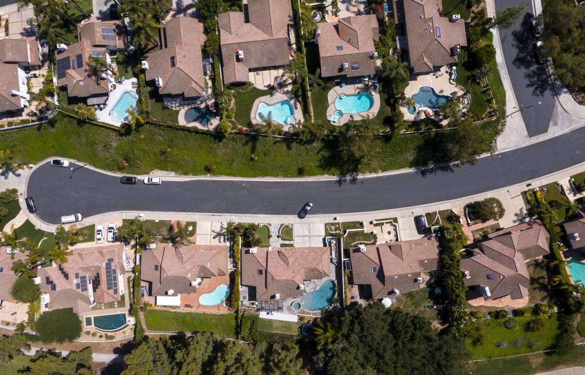 An aerial view of homes — many with swimming pools — around Calabasas Country Club.