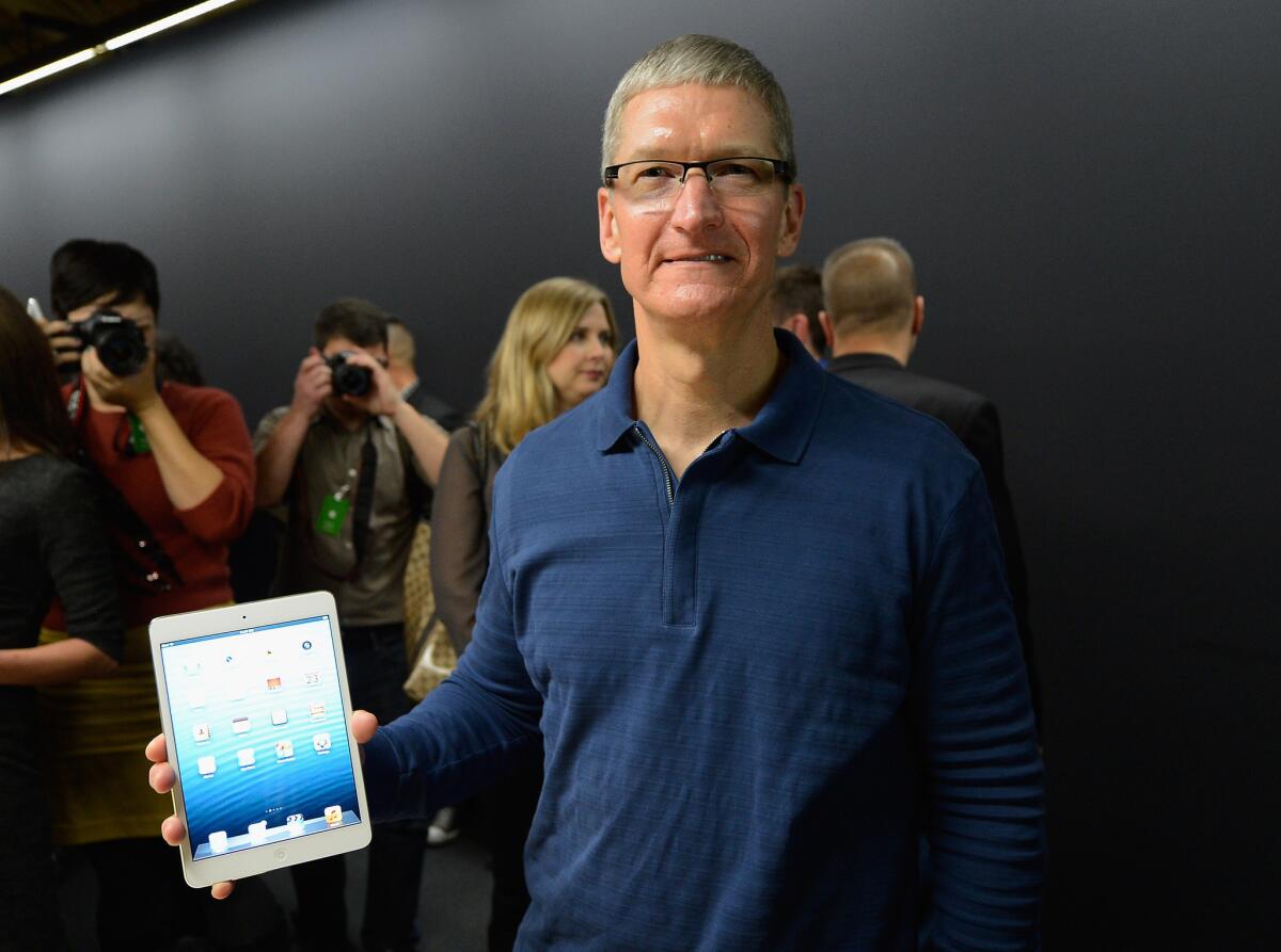 Tim Cook of Apple shows the iPad mini, a smaller version of the iPad tablet, in 2012. An updated iPad mini is expected to be released this year.