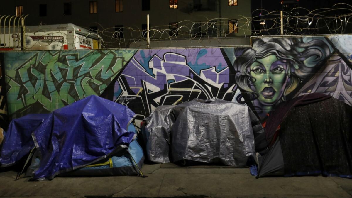 Tents line San Julian Street on skid row. A new data analysis suggests that about 100,000 people experienced homelessness in L.A. County at some point in 2017.