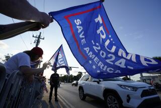 Supporters of former President Donald Trump chant and wave flags during a rally to welcome him back home, Tuesday, April 4, 2023, in West Palm Beach, Fla. Trump is returning to Mar-a-Lago after his arraignment Tuesday in a Manhattan courthouse. (AP Photo/Wilfredo Lee)