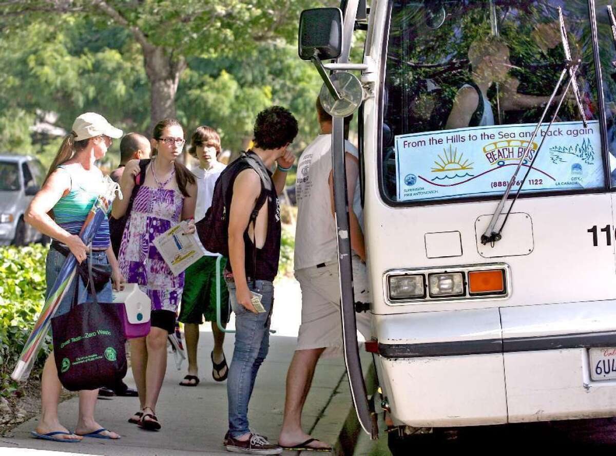 A Los Angeles County bus that transports residents in La Canada Flintridge, Montrose and La Crescenta to Santa Monica returns on June 18. Above, local teens take the bus in 2010.