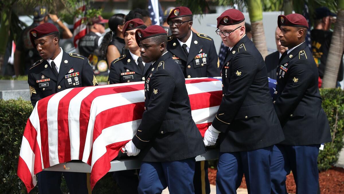 An honor guard carries the casket of Sgt. La David Johnson during his burial service on Saturday in Hollywood, Fla.