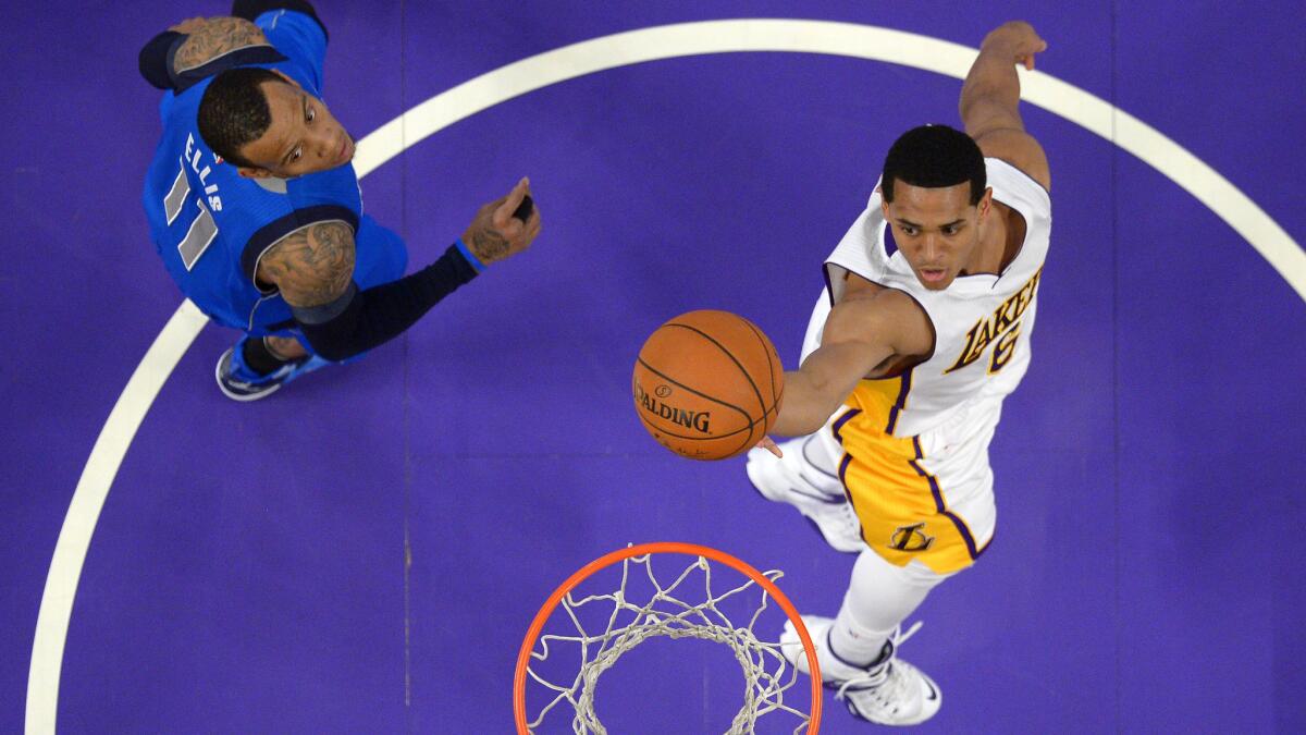 Lakers guard Jordan Clarkson, right, scores over Dallas Mavericks guard Monta Ellis during the Lakers' loss at Staples Center on Sunday.