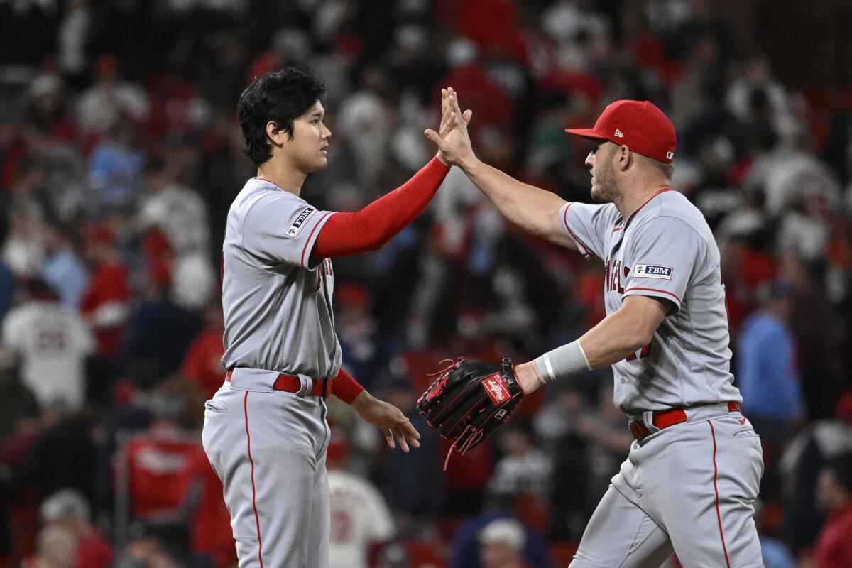 Shohei Ohtani and Mike Trout high five after the Angels beat the Cardinals Wednesday