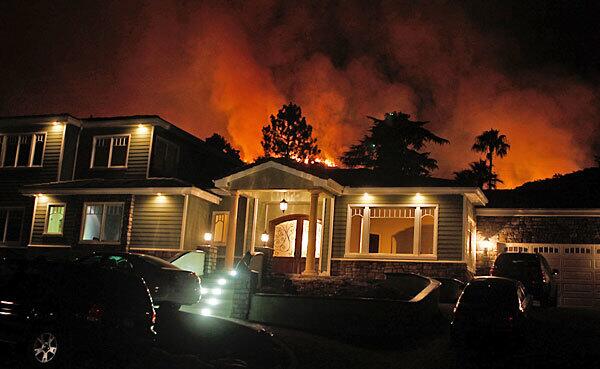 Flames threaten a home on San Gorgonio Road in La Ca?ada Flintridge.
