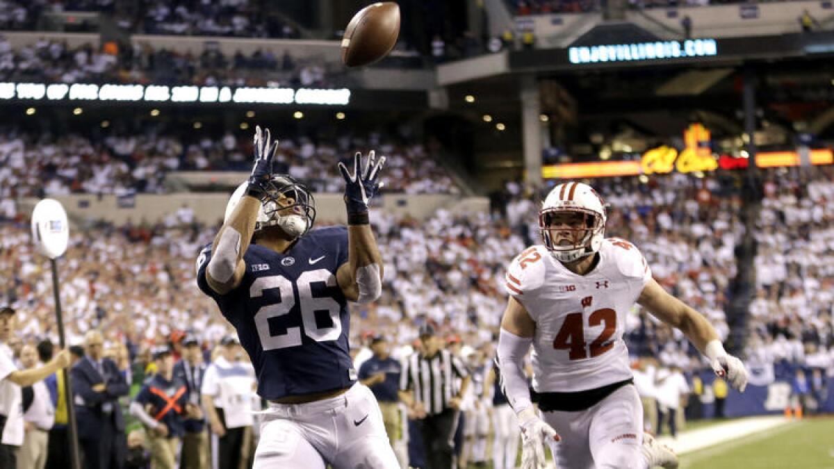 Penn State running back Saquon Barkley makes a touchdown catch against Wisconsin's T.J. Watt.