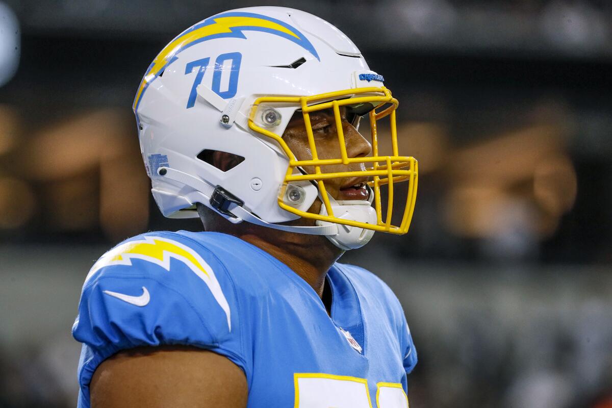  Chargers offensive tackle Rashawn Slater takes a break during an NFL game.