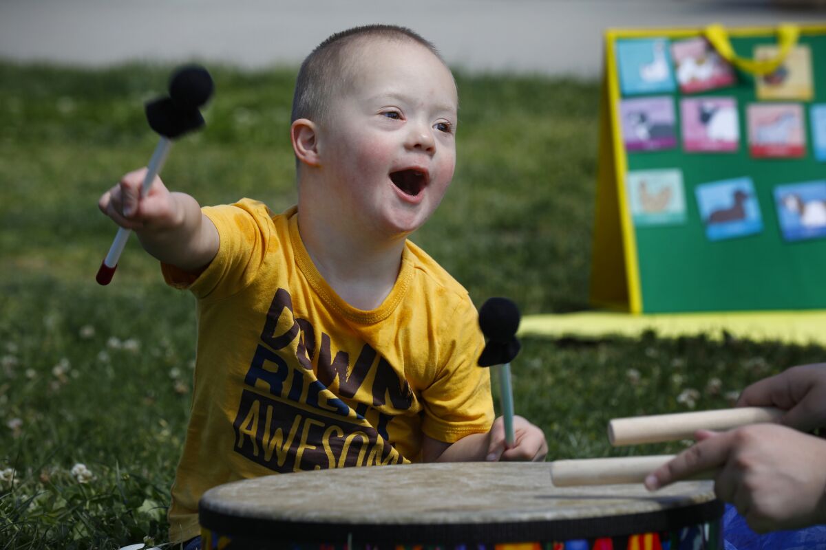 Dean Jaskiw, 3, plays the drums at the World Down Syndrome Day celebration on Sunday.