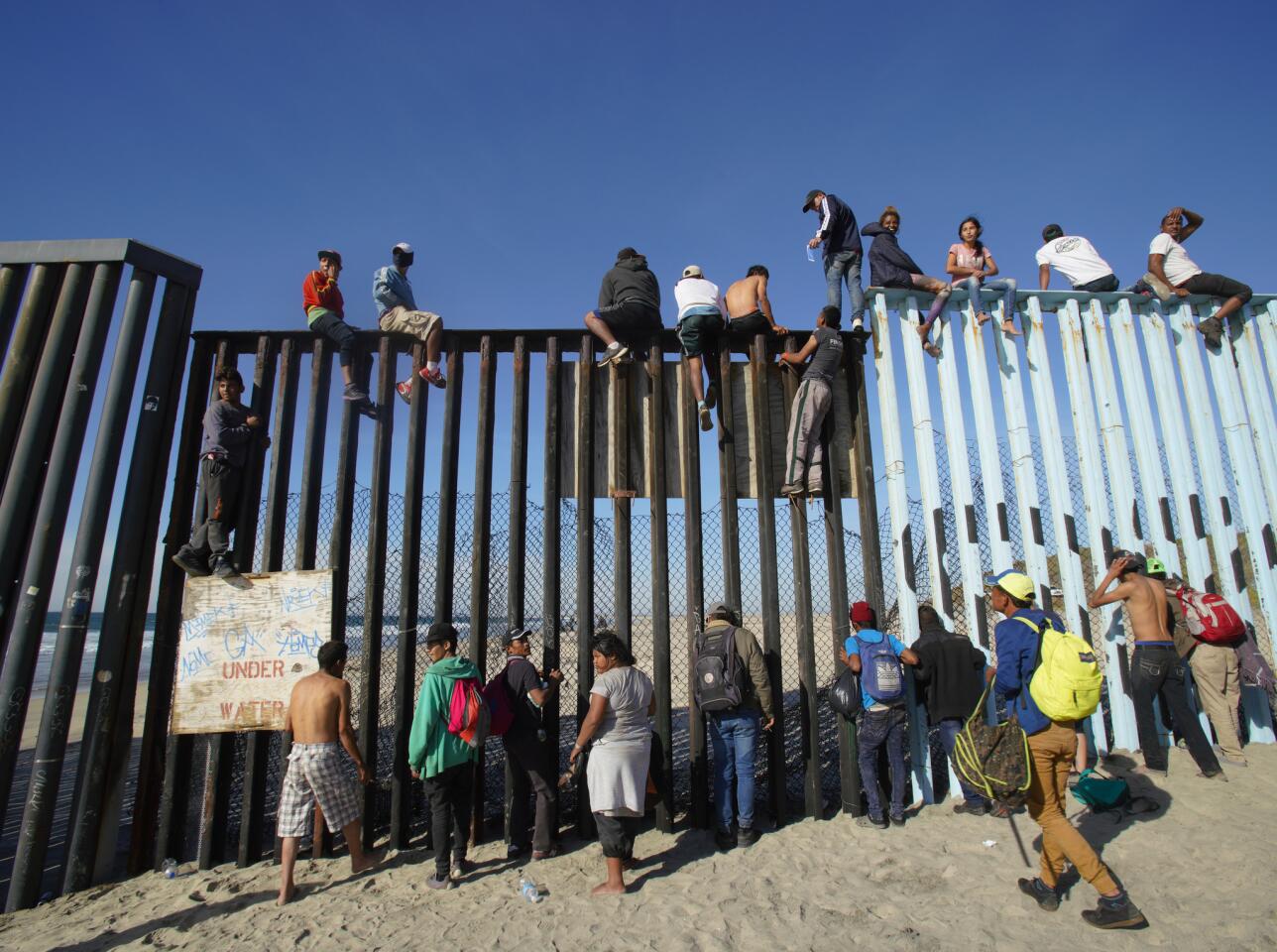 On arrival to the U.S. Mexico border, many climbed the fence with U.S. Border Patrol on the north side of the fence observing.