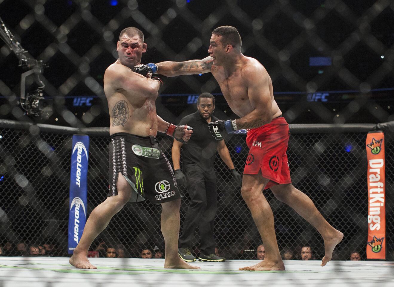Fabricio Werdum lands a punch to Cain Velasquez during their UFC 188 bout Saturday night in Mexico City.