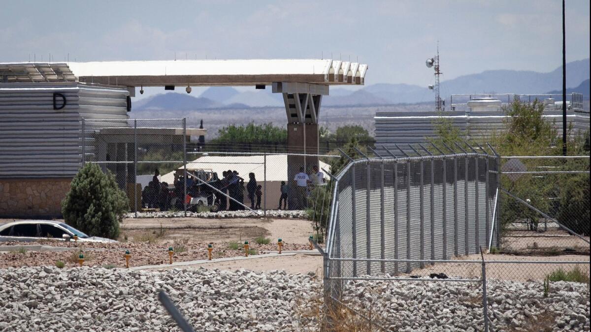 People wait outside the Tornillo-Marcelino Serna Port of Entry, where tents have been built to house unaccompanied migrant children, on June 18 in Tornillo, Texas.