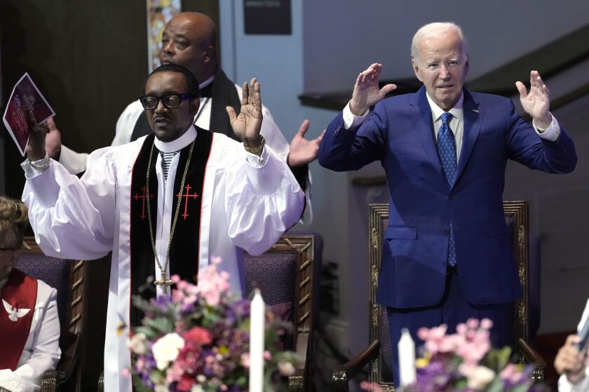 President Joe Biden, right, and pastor Dr. J. Louis Felton pray at a church service at Mt. Airy Church of God in Christ, Sunday, July 7, 2024, in Philadelphia. (AP Photo/Manuel Balce Ceneta)