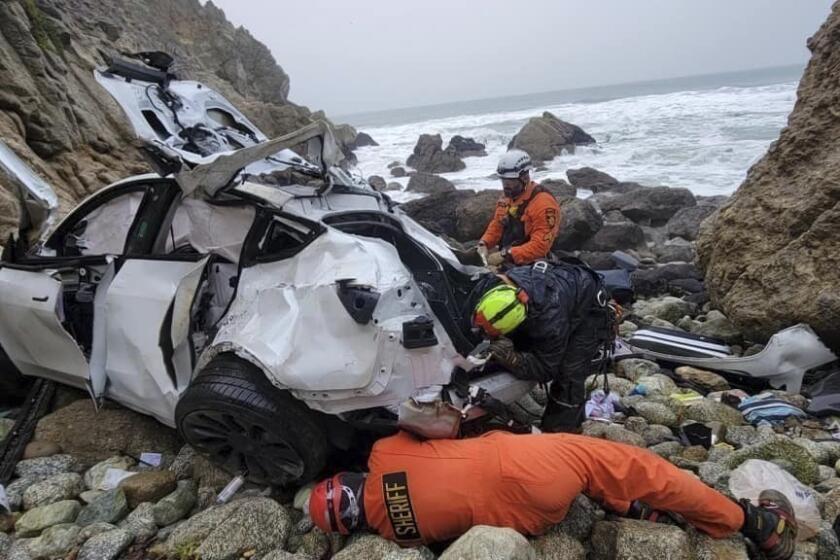 FILE - In this photo provided by the San Mateo County Sheriff's Office, emergency personnel respond to a vehicle over the side of Highway 1 on Jan. 1, 2023, in San Mateo County, Calif. The wife of Dharmesh Patel, a California radiologist accused of trying to kill his family when he drove his Tesla off a cliff along the Northern California coast told rescuers her husband was depressed and needed a psychological evaluation, according to a newly unsealed search warrant affidavit. (Sgt. Brian Moore/San Mateo County Sheriff's Office via AP; File)