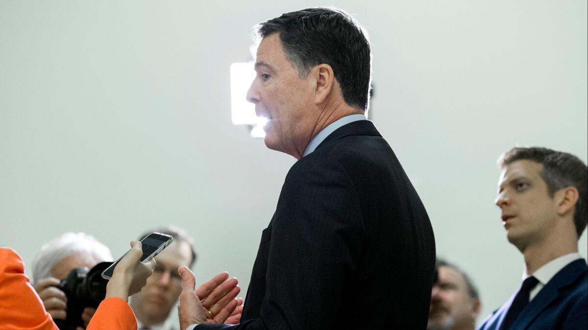 Former FBI Director James B. Comey speaks to the media Monday.