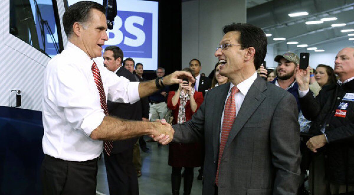 Republican presidential candidate Mitt Romney greets House Majority Leader Eric Cantor while campaigning at Meadow Event Park, in Richmond, Va.