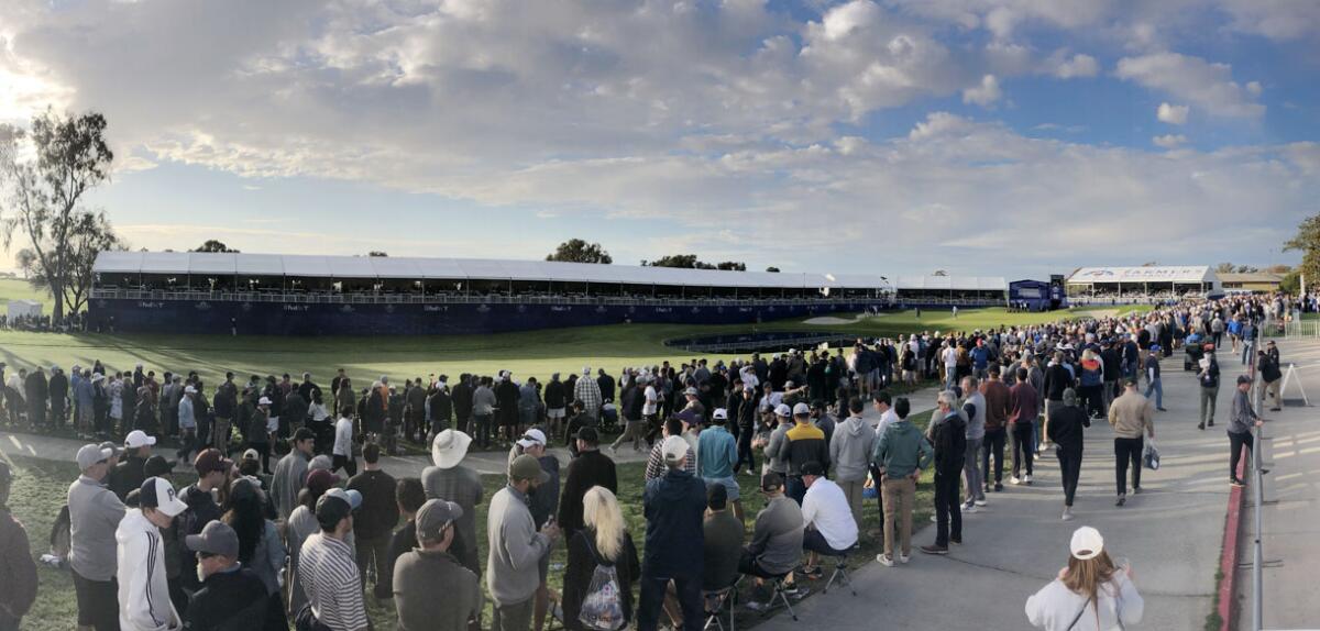 A crowd builds around the South Course's 18th green as evening approaches Jan. 29 during the Farmers Insurance Open.