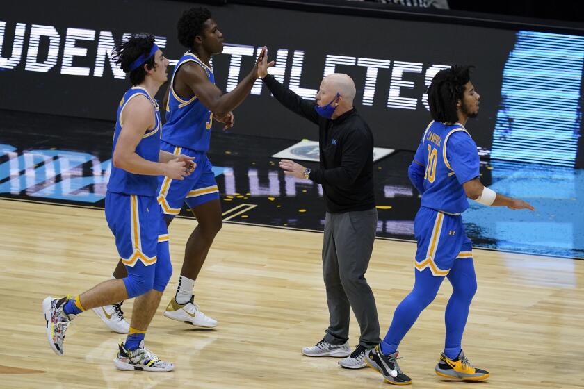 UCLA coach Mick Cronin celebrates with his team during a Final Four game against Gonzzaga on April 3, 2021, in Indianapolis.