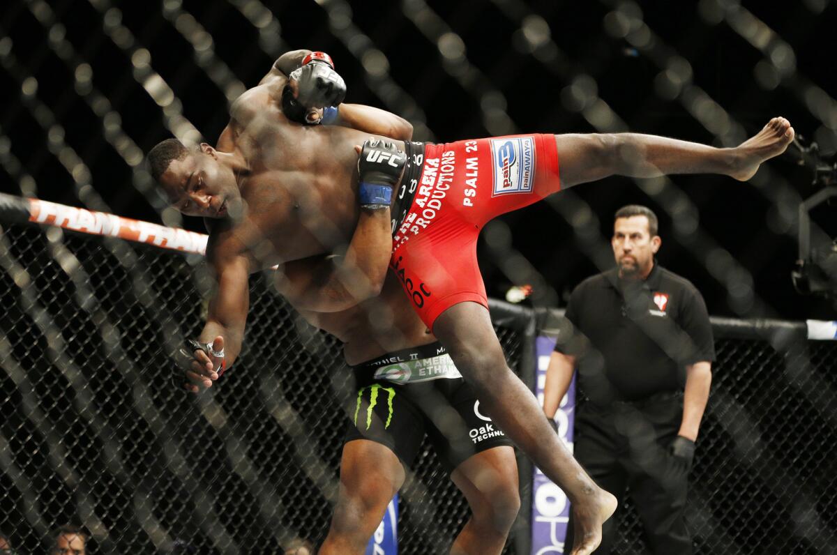 Daniel Cormier lifts Anthony Johnson during their light-heavyweight bout on May 23, 2015, in Las Vegas.