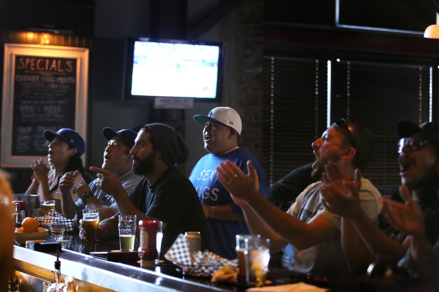 Fans cheer on the Dodgers as they watch the game against the Washington Nationals at the Greyhound Bar & Grill.