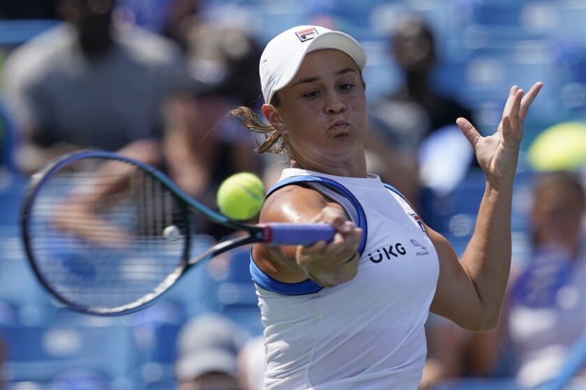 FILE - Ashleigh Barty, of Australia, returns a shot to Jil Teichmann, of Switzerland, in the women's single final of the Western & Southern Open tennis tournament, Sunday, Aug. 22, 2021, in Mason, Ohio. Top-ranked Barty had a tough opener to her 2022 season, having to rally from a set and a break down to beat 17-year-old American Coco Gauff 4-6, 7-5, 6-1 on Wednesday, Jan. 5, 2022, in the second round of the Adelaide International.(AP Photo/Darron Cummings, File)
