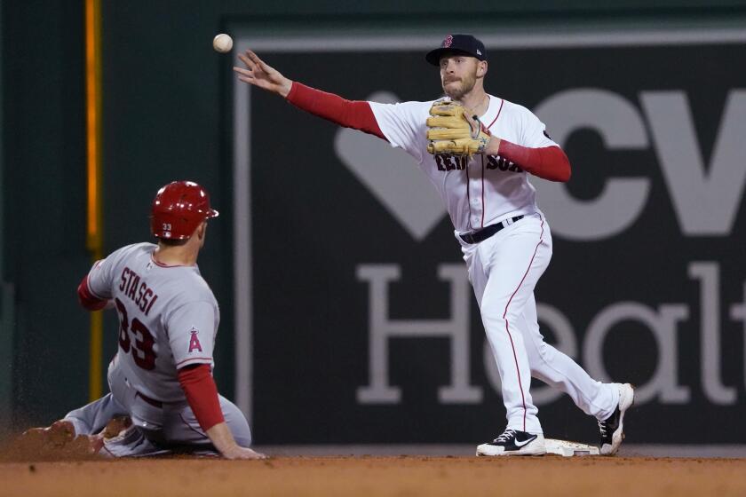 Boston Red Sox second baseman Trevor Story (10) throws to first after forcing out Los Angeles Angels' Max Stassi (33) during the fifth inning of a baseball game at Fenway Park, Tuesday, May 3, 2022, in Boston. David Fletcher was out at first. (AP Photo/Mary Schwalm)