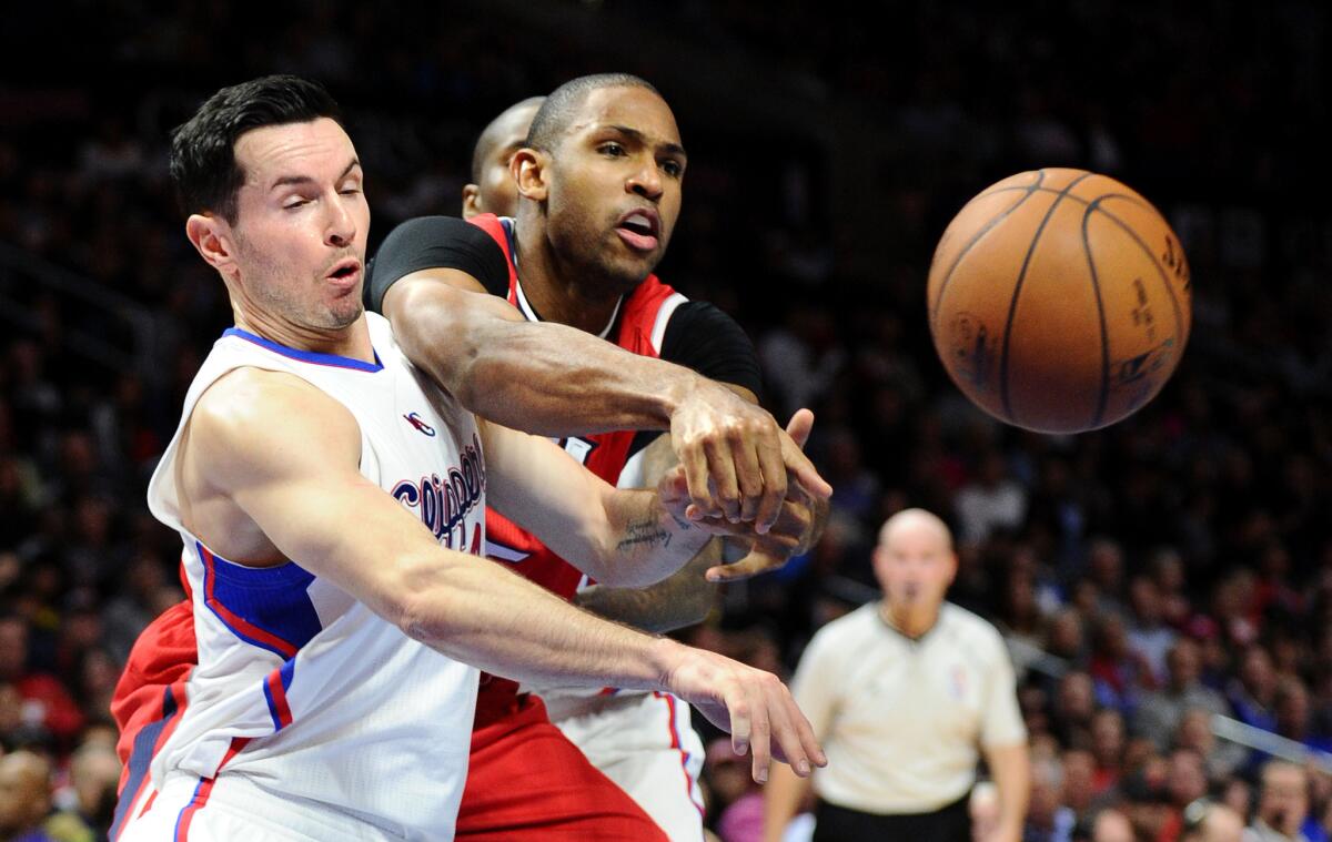 Clippers guard J.J. Redick creates a turnover by knocking the ball from the grasp of Hawks center Al Horford in the second quarter.